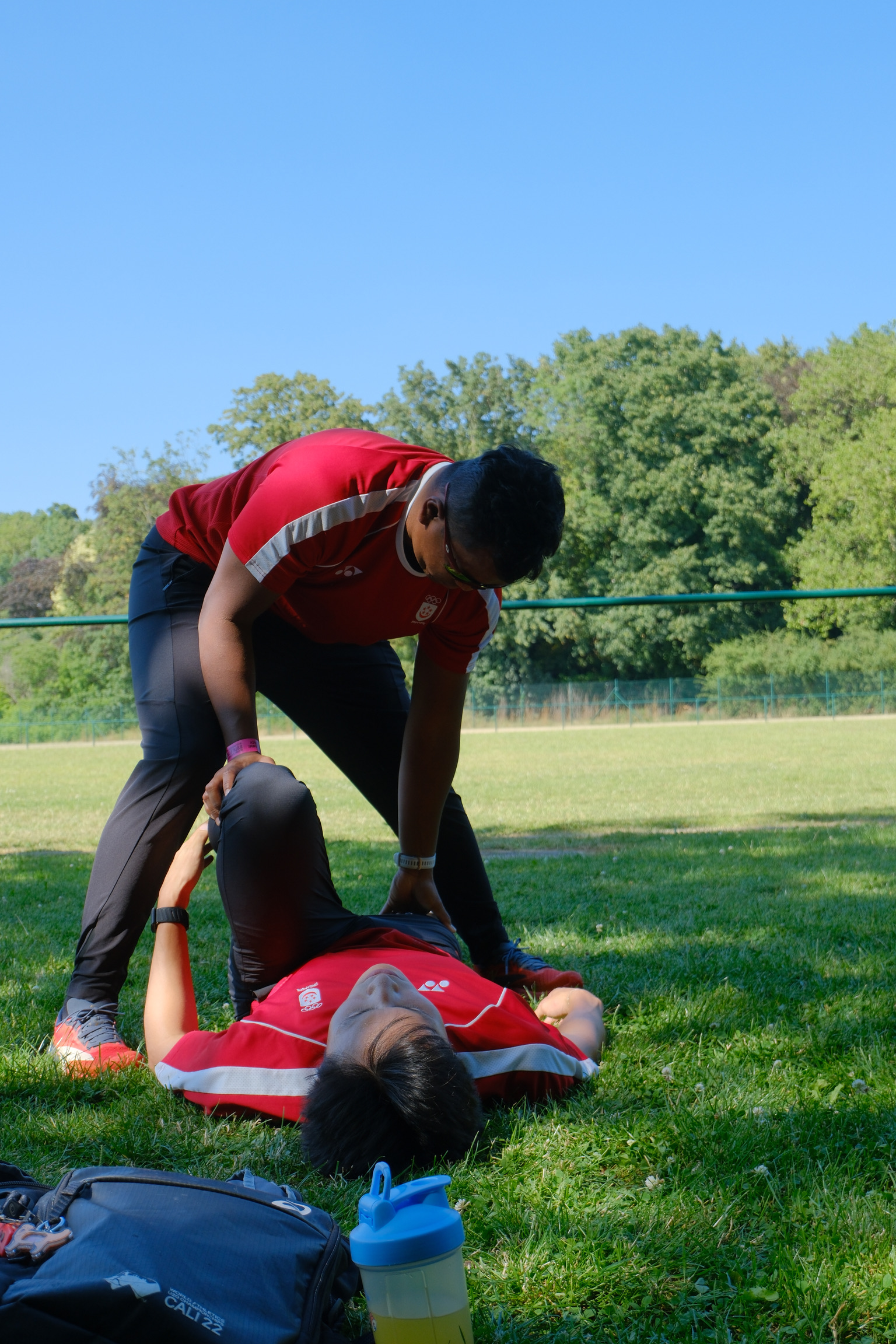 Coach Khai guiding an athlete through a stretch