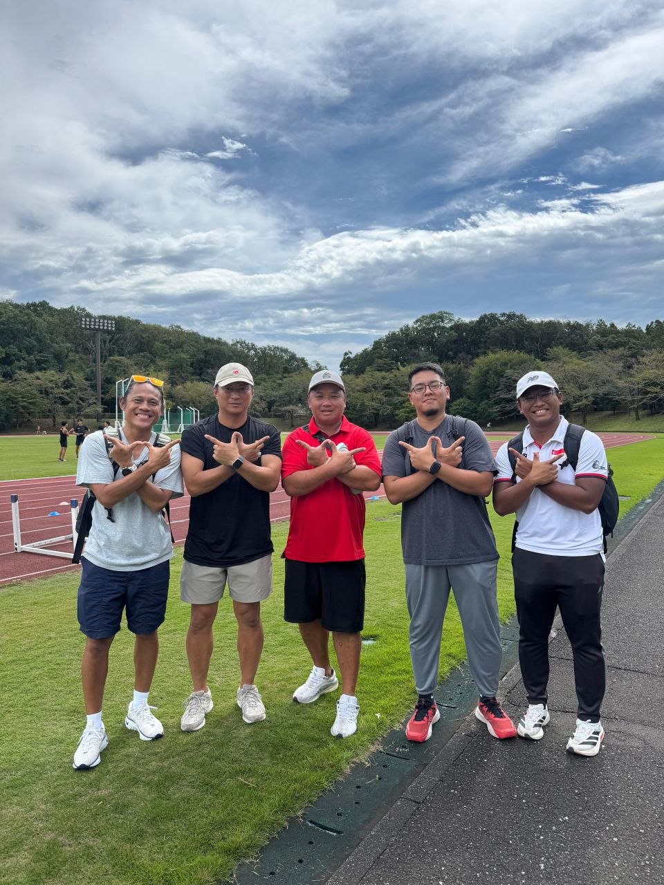 Coach Khai with fellow coaches at the track