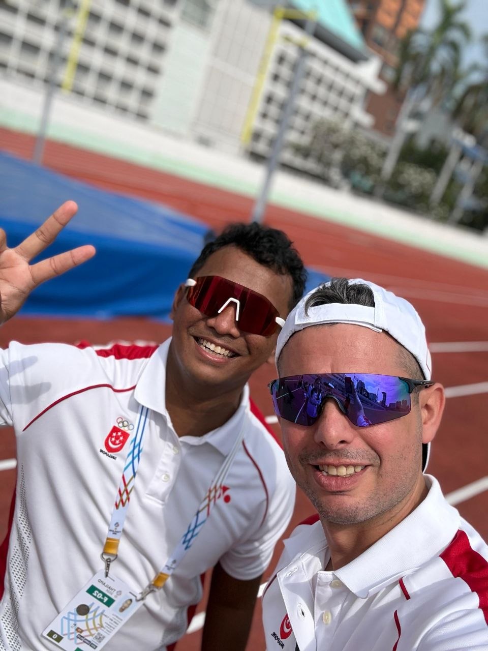Coach Khai with a fellow coach on the competition track