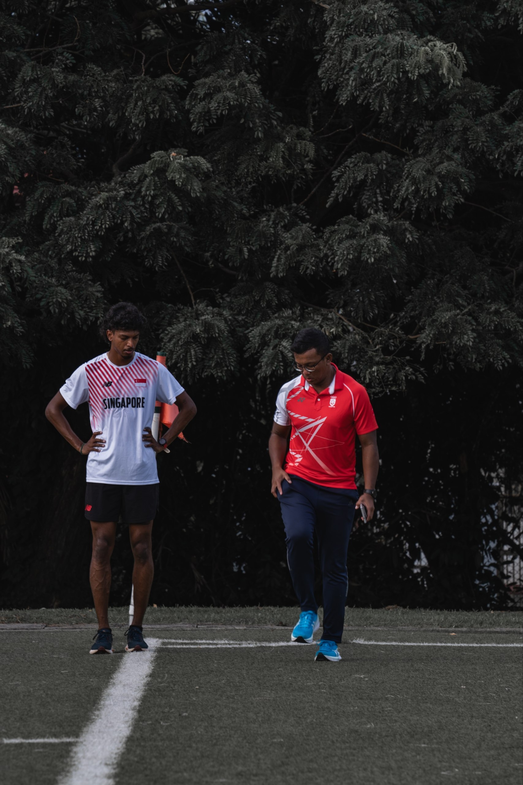 Coach and athlete on the track at Home of Athletics